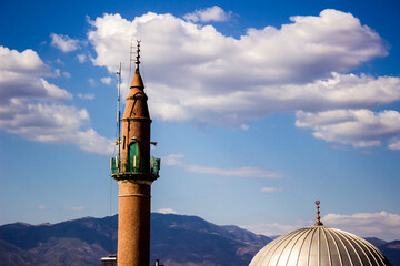 Fototapeta The magnificent harmony of the dome and the minaret with the background of the clouds obraz