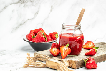 Jar of strawberry jam on white background. Homemade strawberry marmelade and fruits. Long banner format