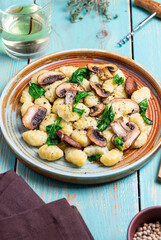 Gnocchi in a creamy sauce with mushrooms and spinach. Healthy eating. Vegetarian food.