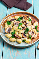 Gnocchi in a creamy sauce with mushrooms and spinach. Healthy eating. Vegetarian food.