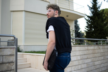 young and modern man entering his yellow-toned villa