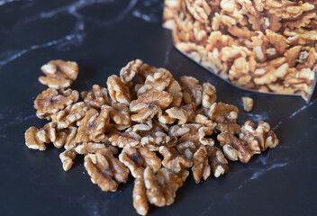 Organic walnuts kernel, nuts on a dark background.