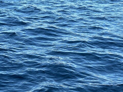 Waves blue water surface with ripples.