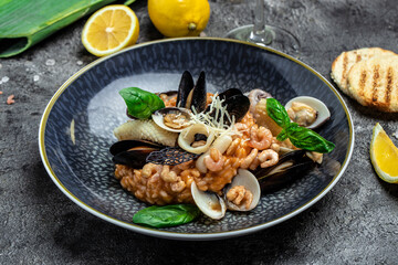 Italian risotto with shrimps, mussels, octopus, clams. Mediterranean cuisine. Restaurant menu, dieting, cookbook recipe top view