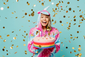 Young excited woman wear domestic costume with hoody and animals ears hold in hand birthday cake...