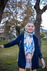young woman in hijab smiling at camera