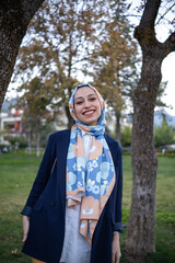young woman in hijab smiling at camera