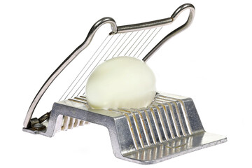 vintage aluminium egg slicer with hard-boiled chicken egg isolated on white background