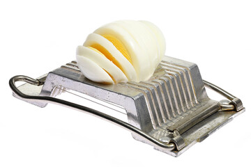 vintage aluminium egg slicer with hard-boiled chicken egg isolated on white background