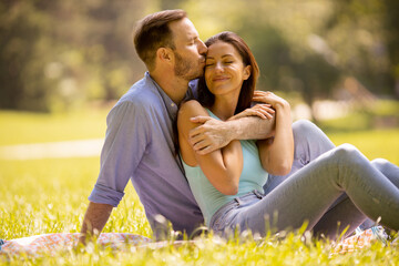Happy young couple in love at the grass field