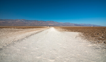 Badwater basin salt flats trail, unique trail at the lowest point in North America. Badwater salt flats and Black Mountains in Death Valley National Park, California