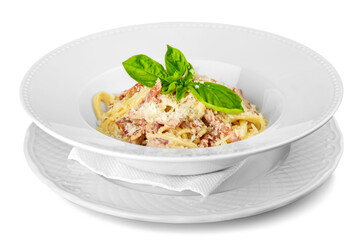 Close-up of tasty pasta with basil in white plate isolated on white background