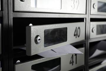 Fototapeta premium Open mailbox with keyhole, number and receipts, closeup