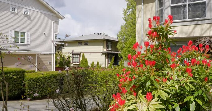 Establishing shot of modern apartment building with beautiful spring blossom landscape in Vancouver, Canada, North America. Day time on April 2022. ProRes 422 HQ.