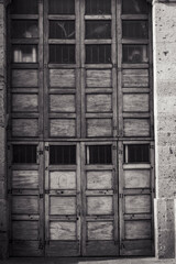 Old wooden door with square repetition modules,vertical image.