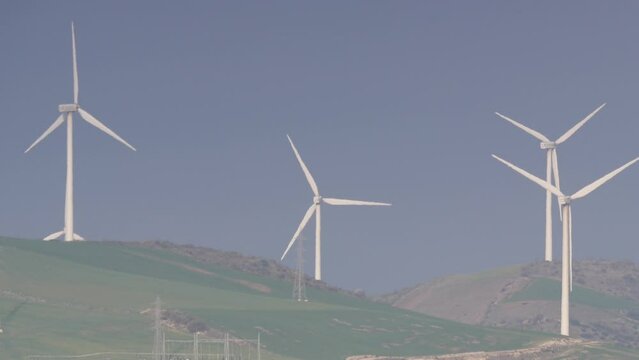 Wind turbines on hills. Power generator farm for renewable electric energy production near Ardales, province Malaga, Andalusia Spain. Zoom out