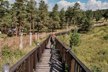 Man going along wooden footpath for ritual detour around buddhist temple. Ulan-Ude, Russia.