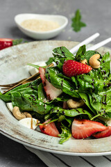 Strawberry salad, Fresh vegetarian salad on gray stone background, banner, menu, recipe place for text, top view