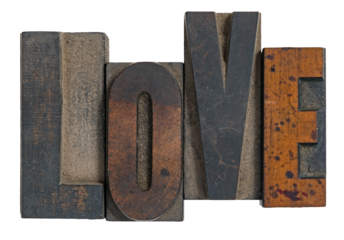 Isolated love spelled out in wooden vintage letterpress type printing blocks