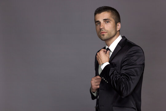 Respectable man in a strict black suit isolated, suit advertisement, luxury.