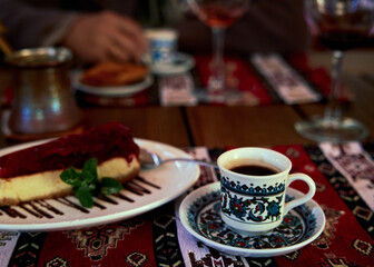 Coffee cup on the restaurant table with blured background. Table setting in a Crimean Tatar restaurant in Odessa, Ukraine..