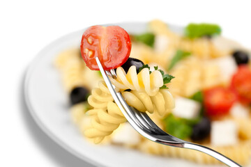 Delicious pasta with vegetables on white plate on white background