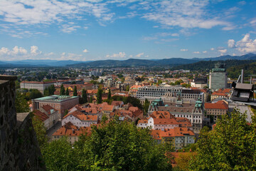 Fototapeta na wymiar The city of Ljubljana in central Slovenia viewed from the historic castle on Castle Hill. Part of the castle walls can be seen on the left 