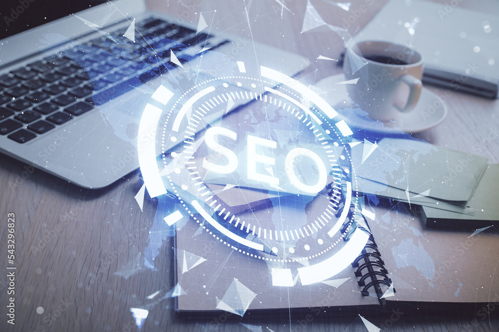 Poster Double exposure of SEO writing and desktop with coffee and items on table background. Concept of search optimization.