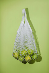 Fresh green apples in a string bag, zero waste grossery shopping concept