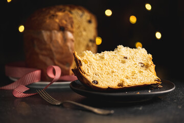 Panettone Christmas Cake. Italian sweet bread on plate on dark table.