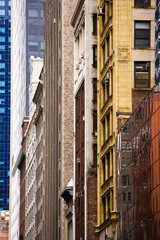 Street view of reflective, colorful row of buildings in a city