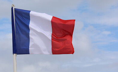 Naklejka na ściany i meble large French flag flying in Paris European capital