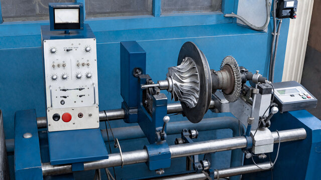 Old machine for balancing the turbine rotor. Turbocharger repair and maintenance.