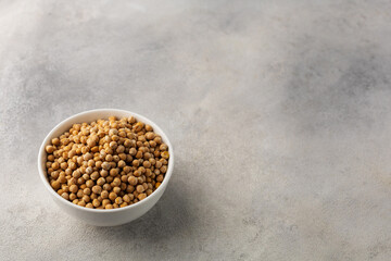 A bowl of raw chickpeas on a light background