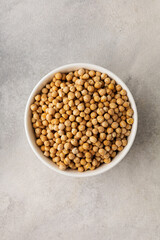 A bowl of raw chickpeas on a light background