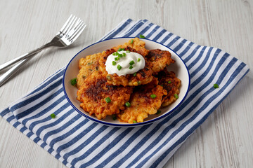 Homemade Fried Cheddar Corn Fritters on a Plate, side view.