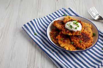 Homemade Fried Cheddar Corn Fritters on a Plate, side view. Copy space.