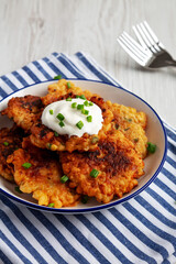 Homemade Fried Cheddar Corn Fritters on a Plate, side view.