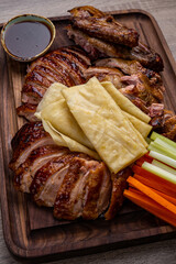 Baked duck. Sliced baked duck on a wooden board. Ketchup