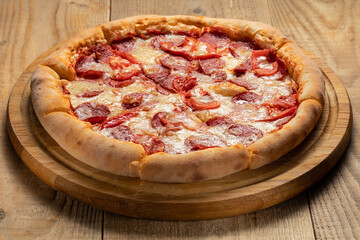 Delicious pizza served on wooden plate