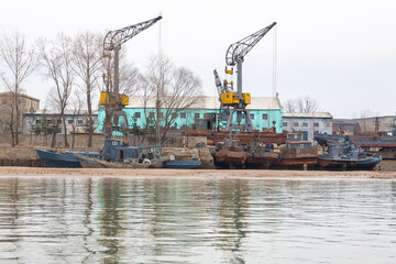 DANDONG, CHINA: boats docked in Sinuiju, North Korean side of Yalu River - obrazy, fototapety, plakaty