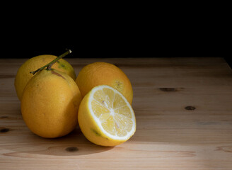 cut yellow lemons with dark background
