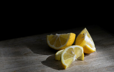 cut yellow lemons with dark background
