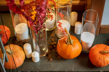 Halloween decor in room, pumpkins and and candle