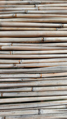 Background texture of dry bamboo cane. Flat lay, vertical frame, close-up