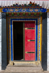 DRIGUNG TIL MONASTERY, CHINA: traditional colorful wooden carved door, Tibet