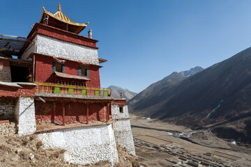 DRIGUNG MONASTERY, TIBET: general view of colorful buildings and dry sunny winter landscape....