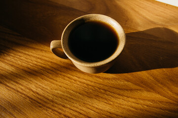 a cup of coffee on the parquet floor