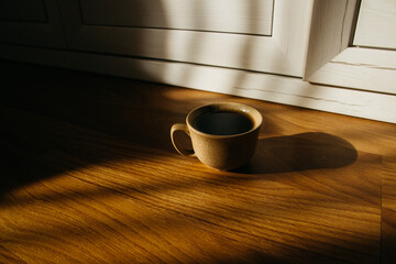 a cup of coffee on the parquet floor