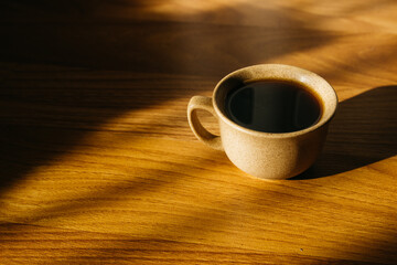 a cup of coffee on the parquet floor